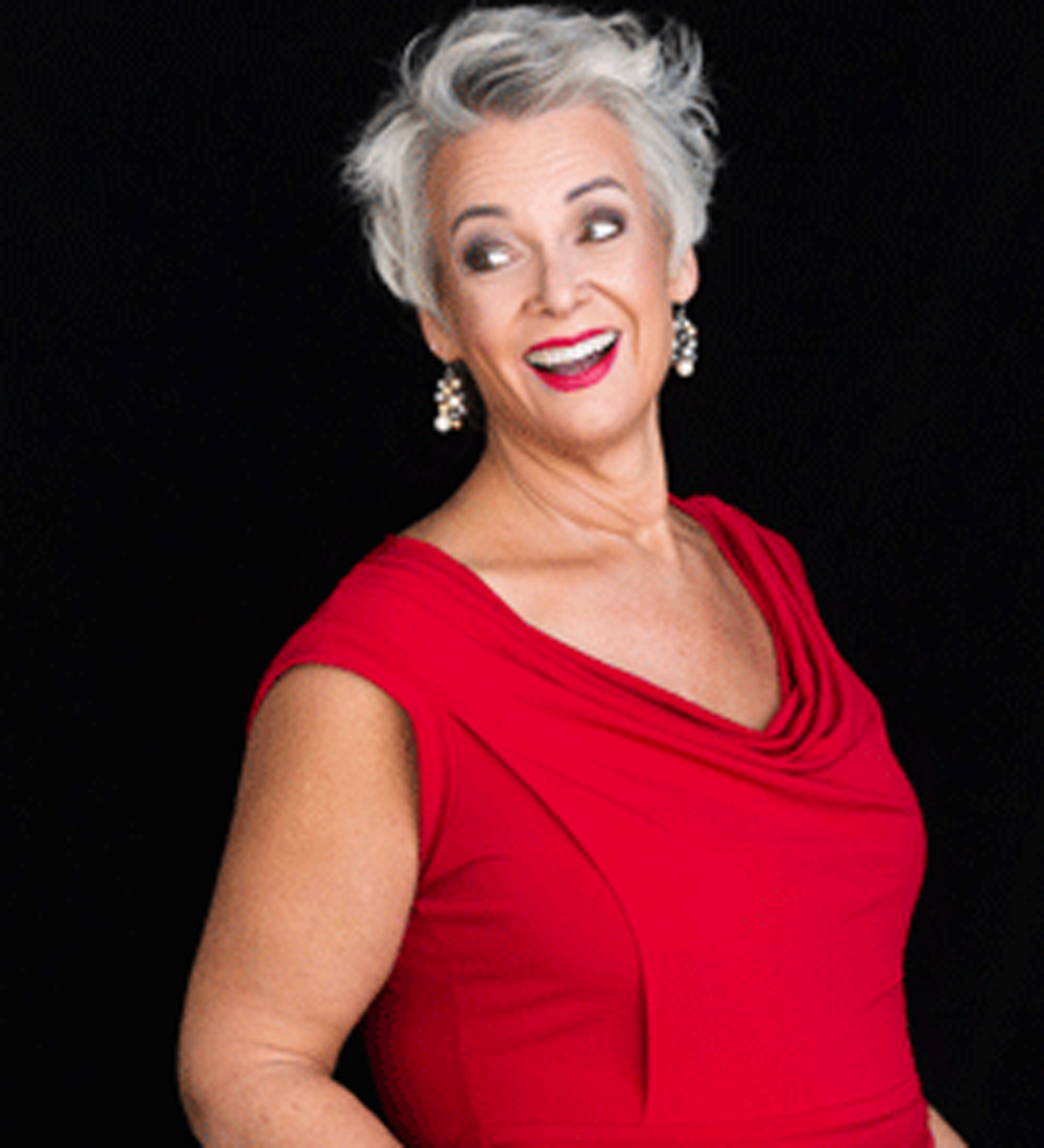 Lizabeth Knight caucasian female with short silver hair wearing a red dress.